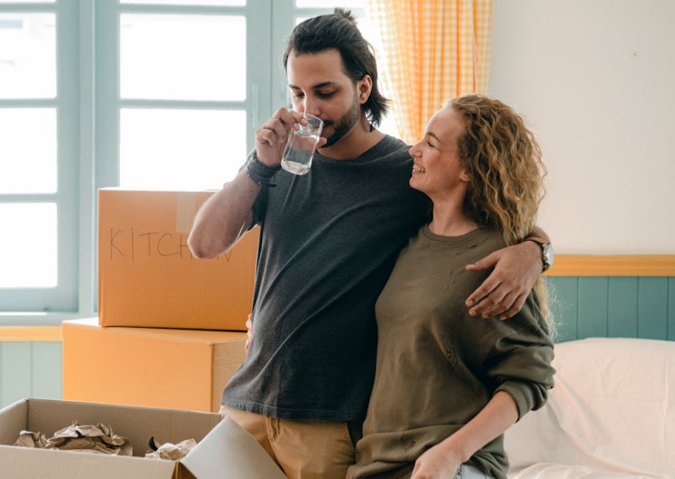 Couple moving into a home with boxes in the background